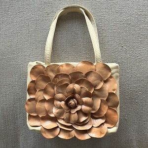 Tan pocket book with flower
